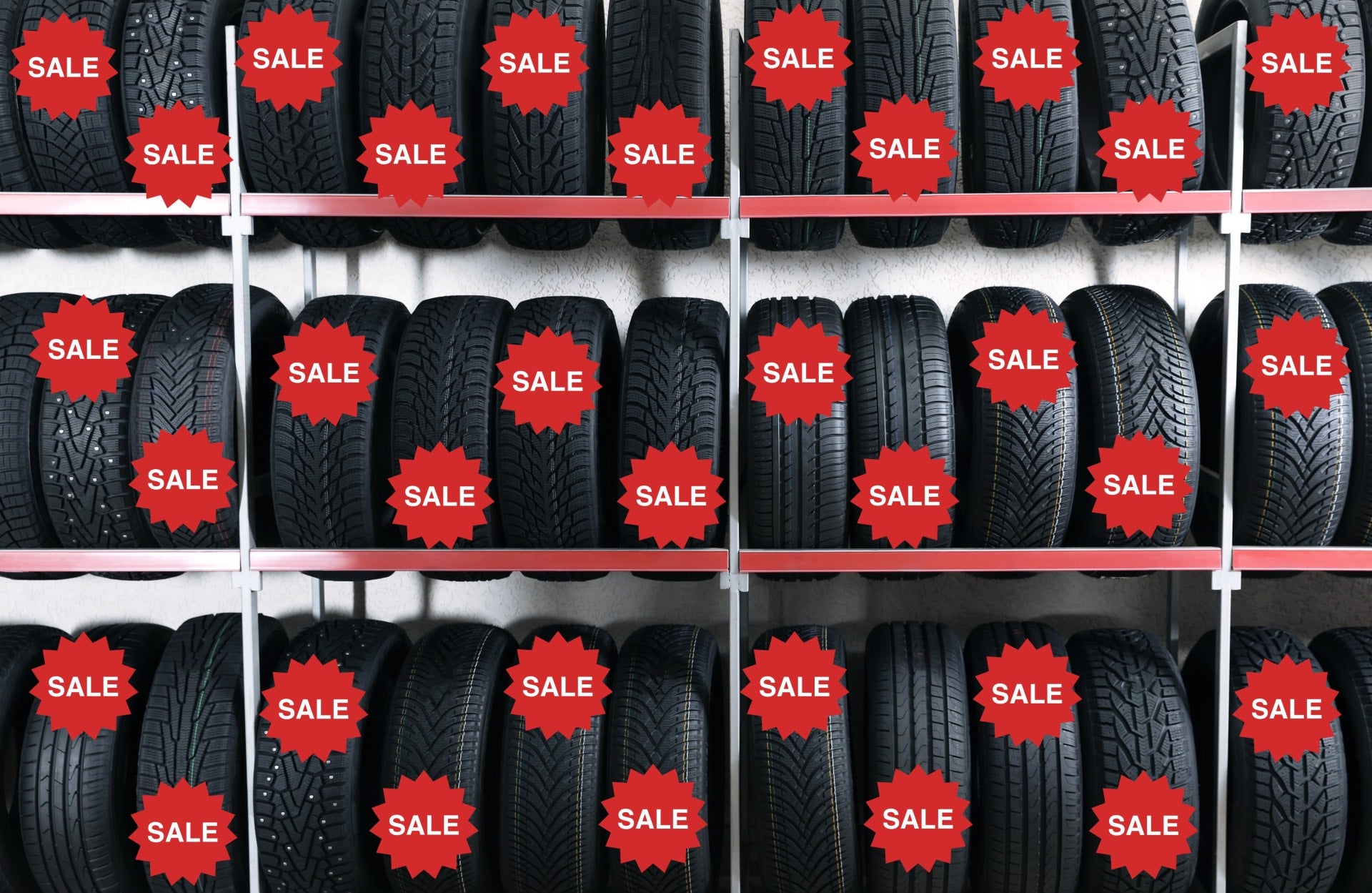 Tires on racks with a sale sign